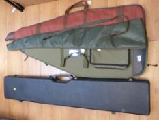 A hard plastic gun case and three gun slips