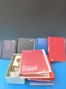 A box of all-world stamps albums and loose stamps