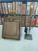 A mahogany coal scuttle with shovel and a companion set