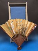 A paper picture of beach huts on a frame in the form of a deck chair to seat together with a large