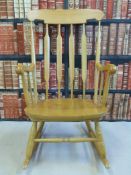 A beech rocking chair with stick back and turned legs