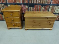 A pine blanket box together with a three-drawer bedside cabinet
