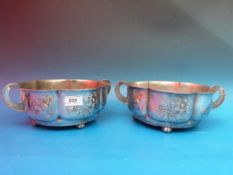 A rare pair of Orivit pewter salad or fruit bowls, both with twin handles and decorated with