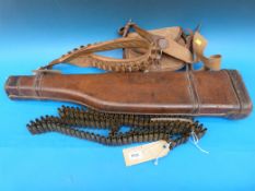 A leather leg of mutton gun case, cartridge bag, cartridge belt and 2. fired .303 cartridge