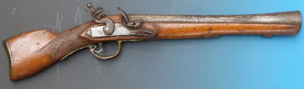 A 19th/20thC flintlock pistol with white metal inlay to barrel and etched decoration to side plates