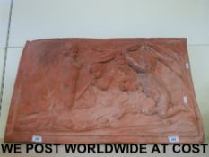 A large and impressive rectangular terracotta plaque with relief decoration of cherubs starting a
