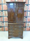 A serpentine fronted cabinet over four graduated drawers with brush slide (H 154cm x W 72cm)