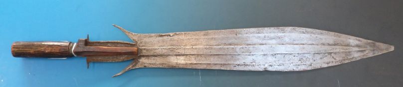 An Eastern (possibly Indonesian) double edged knife with wooden handle, length 62cm