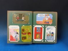 An album of mainly comic postcards to include Isle of Wight railways, McGill, Bruce Bairnsfather