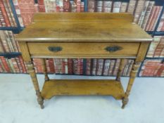 An oak wash stand with under-shelf