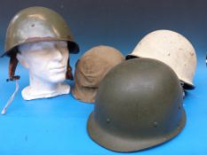 Four various military helmets to include Iraq