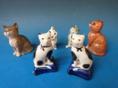 A collection of ceramic cats including Staffordshire, Beswick etc