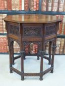 A c1900 Middle Eastern style octagonal table of small proportions with inlaid top and pierced