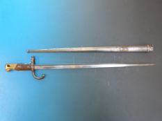 A French bayonet in scabbard with brass and wooden handle, the blade marked St Etienne 1878