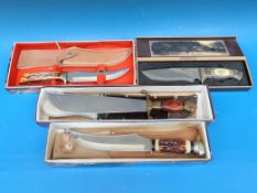 A collection of boxed bowie knives