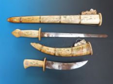 Two Eastern bone swords with erotic scenes to the sheaths and handles