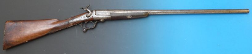 A 12 bore single barrelled hammer action pin fire shotgun with engraved decoration and horn tipped
