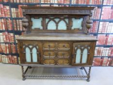 A carved oak sideboard in the carolean style (H 153cm x L 152cm)