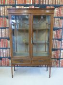 An Edwardian glazed display cabinet with inlaid and cross bonded decoration with drawer under