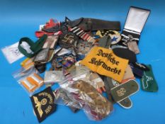 A quantity of original and replica mainly German military fabric badges, ephemera etc