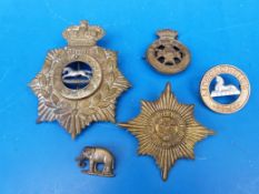 A collection of Victorian badges including home service helmet plate to the West Yorkshire