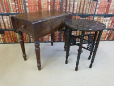 A stained pine Pembroke table and an Eastern carved table