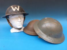 Three WW2 style tin helmets including a wardens example