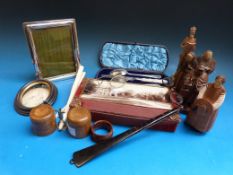 A hallmarked silver photograph frame together with a pair of ivory glove stretchers, wooden figures