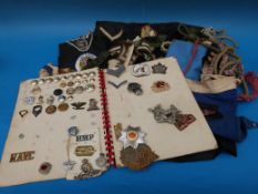 A collection of military badges, buttons and braids etc