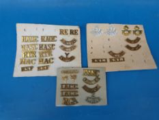 A collection of military epaulette badges including Gloucester, Middlesex, Royal Sussex, Durham,