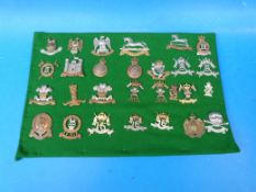 Twenty-eight British Army cap badges of The Hussars and Lancers, WW1, WW2 and post-war examples,