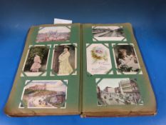 A late 19th/ early 20th century postcard album, to include Royal and popular portraits, stately