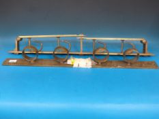 A 19thC brass two-part wall-mountable gun rack (removed from a Staffordshire country house by the