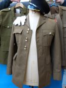 Three Coldstream Guards jackets together with two pairs of trousers, hat and two pairs of gloves.