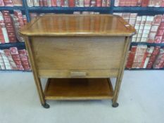 A C. Arnold & Co oak needlework box on wheels