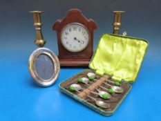 A pair of brass ejector candlesticks together with a cased set of coffee bean shell bowl spoons, an