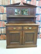 A pine backed sideboard with two drawers above two cupboards