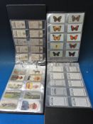 Four green albums containing Players, Wills, Anstie, Senior Service calendars, cigarette cards etc