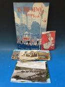 A quantity of postcards, some loose others in a scrapbook