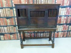 A peg jointed 18th /19thC oak and elm safe on a stand, the safe with turned bobbin grille doors (H