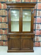 A 19thC glazed mahogany bookcase over cupboard with dogs tooth adjustable shelves (206cm tall x