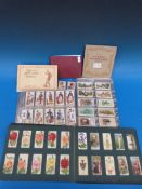 A collection of cigarette cards including Wills European Royalty (100), Aviation, Roses, Railway