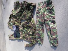 A quantity of camouflage uniform and various berets