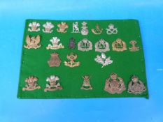 Twenty-two British Army cap badges largely Yeomanry, including Derbyshire, Ayrshire,