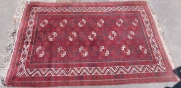 A Bokhara carpet with red ground and typical geometric design (350cm x 226cm)