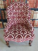 A 19thC nursing chair with turned front legs and button back