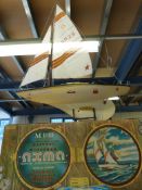 A boxed racing yacht with electric motor driven propeller and controlled steering