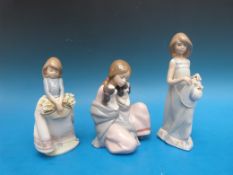 Three Lladro fingurines of ladies (tallest 19cm)