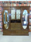 A Waring and Gillow compactum, the centre section having glazed cupboards,