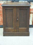 A small oak writing or jewellery cabinet, the interior fitted pigeon holes and drawers,